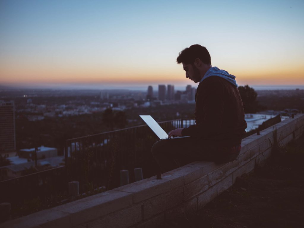 Male Laptop High Rise Building NESA Policy and Research Papers